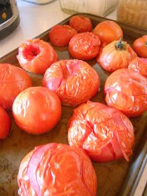 tomatoes on a baking sheet ready to be cooked in the oven with oil over them