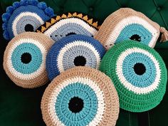 four crocheted round baskets sitting on top of a green chair