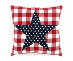 a red and white checkered pillow with a blue star on the front, sitting on top of it