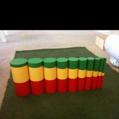 a group of cylinders sitting on top of a green rug