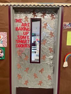 a classroom door decorated with gingerbreads and we are baking up some smart cookies