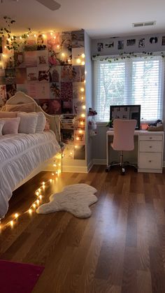 a bedroom with lights strung from the ceiling and a bed in front of a window