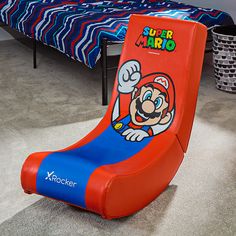 an inflatable chair is sitting on the floor next to a bed with a blue and red bedspread