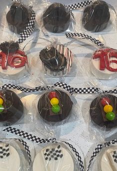 a table topped with lots of cupcakes covered in chocolate