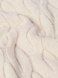 the texture of a white blanket is shown in close - up view, as if it was made from wool or cashmere