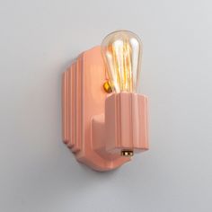 a light that is on the side of a wall with a bulb in it's center