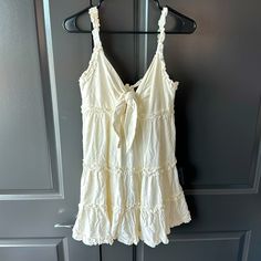 Selling Small White/Cream Colored Lulus Dress New With Tags White V-neck Mini Dress With Tie Straps, Cream Mini Sundress For Summer, Cream Sundress For Vacation, White Sundress With Tie Straps, Off White Sundress Mini Dress For Day Out, Cream V-neck Sundress For Day Out, Off White Ruffled Beach Dress, Cream Ruffled Sundress For The Beach, White Tie Straps Mini Dress For Beach