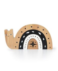 a wooden toy with a black and white design on the front, it is shaped like a snail