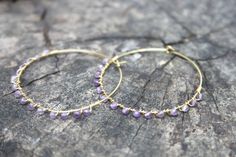 "earrings, dangle earrings, trendy jewelry, boho jewelry, beaded hoops, hoop earrings, bronze hoops, seed bead hoops These raw brass hoop earrings have been wrapped with tiny faceted amethyst beads, the hoops measure 1.5\" in diameter." Festival Brass Wire Wrapped Hoop Earrings, Purple Bohemian Round Hoop Earrings, Bohemian Purple Round Hoop Earrings, Wire Wrapped Hoop Earrings For Festivals, Festival Wire Wrapped Hoop Earrings, Purple Bohemian Hoop Earrings, Bohemian Purple Hoop Earrings, Nickel-free Purple Hoop Earrings, Etsy Rings