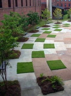 an empty courtyard with grass in the middle