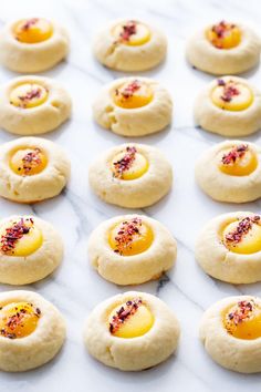 several small cookies are arranged on a baking sheet and ready to go into the oven