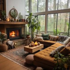 a living room filled with furniture and a fire place in the middle of a room