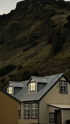 a house in front of a large mountain