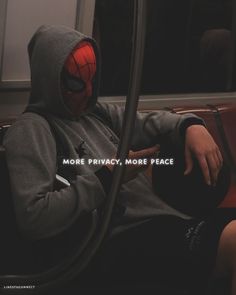 a person wearing a spider man hoodie sitting on a train with the words more privacy, more peace