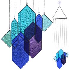 three colorful stained glass wind chimes hanging from chains on a white background, one is blue and the other is purple