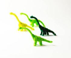 several small plastic dinosaurs in different colors