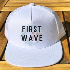 "First Wave " first birthday white mesh snap back hat with adjustable straps. * Trendy Mesh Snap Back Hat * Features a Firm Rectangular Brim * 100% Polyester * 48 cm Circumference * Snap Back Closure White Summer Trucker Hat For Vacation, White Trucker Hat For Beach Season, White Snapback Trucker Hat For Beach, White Baseball Cap For Beach Vacation, White Summer Baseball Cap For Beach Season, Summer White Baseball Cap For Beach Season, Fun White Trucker Hat For Beach Season, Fun White Hat For Beach Season, Vacation White Trucker Hat One Size