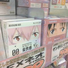 several boxes with anime characters on them in a store