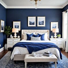 a bedroom with blue walls, white furniture and pictures on the wall above the bed