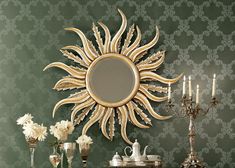 a table topped with a mirror next to a vase filled with white flowers and candles