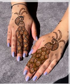 two hands with hendi designs on them