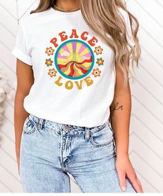 "Peace, Love Retro Tshirt! This shirt brings us back to a better time, a time when things were groovy and there was peace and love. Show the world that you support peace!  Light fabric, tear-away label, runs true to size - see size chart and color chart. HOW TO ORDER: 1) Please review all photos for size and color options before ordering. 2) Choose your shirt size and color. Please be aware that colors may differ slightly from their appearance on screen. 3) Click \"Add to cart\". PRODUCTION and SHIPPING Production and processing are generally 1-3 days with shipping between 2-7 business days (after processing and production time). CANCELLATION POLICY We are happy to accept cancellations within 1 hour of purchase. If later than one hour, please contact us to make sure we haven't started prod Retro White T-shirt With Funny Print, Hippie Printed Crew Neck T-shirt, Vintage Summer Tops With Custom Print, Vintage Custom Print Tops For Summer, Retro Custom Print Summer Tops, White Hippie T-shirt For Spring, Retro White Top With Custom Print, White T-shirt With Retro Print For Spring, Groovy Short Sleeve T-shirt With Retro Print