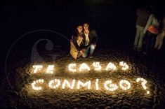 two people standing in front of a lit sign that says, we can't connect