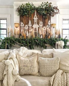 a living room filled with white furniture and christmas decorations