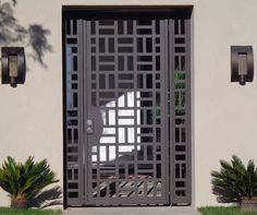 an iron gate is open on the side of a house