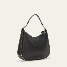 Valentino Garavani hobo bag in calfskin leather with Rockstud trim  Detachable shoulder strap  Zip top closure  Interior, one slip pocket  Approx. 11"H x 14.1"W x 2.3"D Made in Italy Elegant Leather Bag With Studs, Elegant Studded Leather Bags, Luxury Studded Shoulder Bag, Formal Leather Bags With Studs, Everyday Leather Shoulder Bag With Studs, Elegant Studded Shoulder Bag For Everyday Use, Luxury Hobo Bag With Gunmetal Hardware For Shopping, Luxury Studs Bags For Everyday, Designer Leather Shoulder Bag With Studs