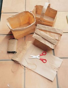 some brown paper bags and scissors on the ground