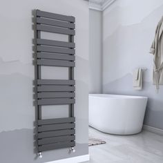 a white bath tub sitting next to a wall mounted radiator