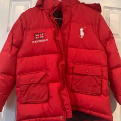 Brand New Jacket By Polo Ralph Lauren In Red. It Is Puffy And Has Very Good Insulation. The Sleeves Have Zipper That Can Be Removed And Use As A Vest. Very Comfy And Warm. Size 2xl For Kids But Can Be Used For Adult Size Small As Well. Red Puffer Jacket With Pockets, Red Puffer Jacket With Detachable Hood, Red Hooded Outerwear With Pockets, Red Hooded Puffer Jacket With Pockets, Red Long Sleeve Outerwear With Detachable Hood, Red Long Sleeve Puffer Jacket With Padded Collar, Red Outerwear With Padded Collar For Streetwear, Red Padded Collar Outerwear For Streetwear, Casual Red Outerwear With Padded Collar