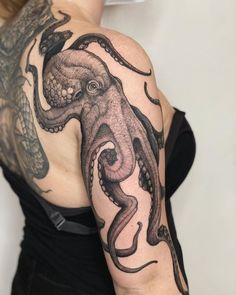 an octopus tattoo on the arm and shoulder