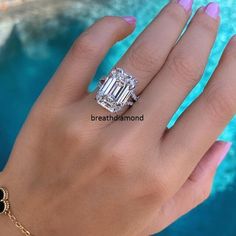 a woman's hand with a ring on it and a diamond in the middle