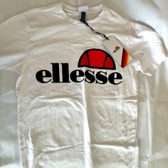 Ellesse T-Shirt,New/W Tag Casual Red Tops With Logo, White Logo Print Shirt For Spring, White Shirt With Logo Print For Spring, Casual White Shirt With Logo Print, Casual Shirt With White Logo Print, White Graphic Tee With Logo, White Crew Neck Shirt With Logo Print, White Short Sleeve Tops With Logo Print, White Short Sleeve Top With Logo