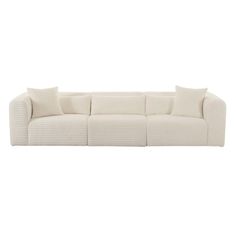 a white couch with four pillows on it