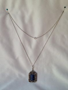 Featuring a vintage circa 1970s Sarah Coventry 'Roman Holiday' necklace, this piece showcases a SilverTone chain with a spring ring closure, intricate silver work, and silver crosses on the metal sections. The pendant boasts an ornate, mottled blue swirl design, mimicking faux blue sodalite cabochon. Styled in the Edwardian fashion.   It is preowned yet remains in exquisite condition.  The necklace measures 24 inches in length, while the pendant is 1 inch wide by 1 3/4 inches tall. For further details on this item, please examine all photos and feel free to message me with any inquiries. After Purchase, If the item is not what you expected, please let me know if there is anything wrong with your item so that I can promptly resolve the issue and ensure your satisfaction.   Don't forget to F Vintage Silver Necklace With Vintage Charm, Vintage Silver Necklaces With Vintage Charm, Sterling Silver Vintage Necklace With Silver Chain, Handmade Retro Silver Jewelry, Ornate Sterling Silver Necklace With Vintage Charm, Retro Silver Necklace With Vintage Charm, Vintage Blue Cabochon Jewelry, Blue Vintage Cabochon Jewelry, Vintage Antique Silver Sterling Silver Necklace