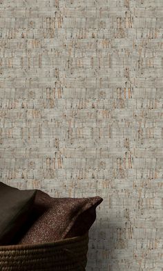 a basket sitting on top of a wooden floor next to a wallpapered wall