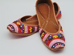 Ethnic Indian/Pakistani style shoes durable, hand stitched with genuine leather sole and leather padded cushion inside. These are for our colorful lovers again who can't get enough of colors. These can go with all your outfits, as well as events. Super lovely design. Very detailed thread embroidered with beads and mirror work on raw jute material. Enjoy the padded cushion for your comfort and style. You will be sure to stand out in these shoes! Sizes available US 5,6,7,8,9,10,11. Bridal Collecti Multicolor Bohemian Flats With Round Toe, Bohemian Embroidered Closed Toe Flats, Multicolor Slip-on Flats For Festival, Embroidered Leather Slip-on Flats, Handwork Flats For Summer Festival, Embroidered Multicolor Flats With Round Toe, Embroidered Multicolor Round Toe Flats, Embroidered Multicolor Slip-on Flats, Multicolor Embroidered Slip-on Flats