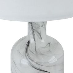 a white table lamp sitting on top of a wooden table