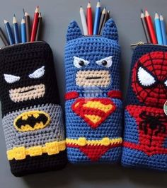 three crocheted pencils are lined up in the shape of batman, superman and spiderman