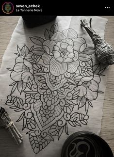 an image of a flower design on a piece of paper next to scissors and other items