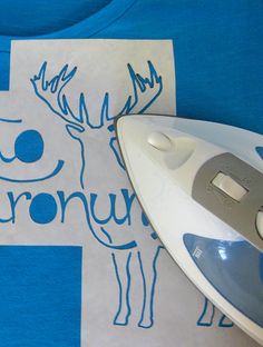 an ironing board with a blue and white shirt on it next to a styrofoam bag