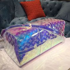 Louis vuitton Keepall Bandouliere 50 Monogram PVC Iridescent Prism By Virgil Abloh For Men, Men’s Bags, Travel Bags 19.7in/50cm LV M53271 Rep 1:1 One of the most highly sought after pieces from Virgil Abloh’s men’s Spring Summer 2019 collection, this holographic coated keepall is already a cult favorite. The duffle features the iconic LV monogram print against an iridescent clear and pink coated canvas. An adjustable crossbody strap is included for optimal comfort and support. Attached to Baby Tote Bag, Pvc Trim, Louis Vuitton Keepall, Fancy Bags, Lv Monogram, Bottega Veneta Shoulder Bag, Monogram Prints, Virgil Abloh, Evening Clutch Bag