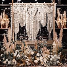 an elaborate table setting with white flowers and feathers