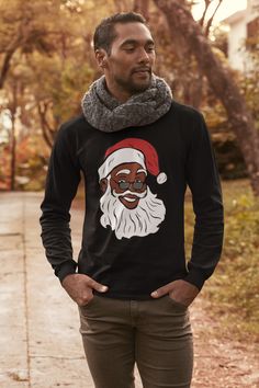 "Black Santa Claus Christmas Shirt | African American Christmas Long Sleeve T Shirt | Holiday Shirt | Black Owned Shops 🎁 Casually elegant, with an excellent quality print it is an irreplaceable everyday item .: 100% Cotton Solid Colors(Athletic Heather is 90% cotton, 10% polyester) .: Medium fabric (4.2 oz/yd² (142 g/m .: Sewn in label .: Runs smaller than usual SIZE CHARTS (Chest size is measured across the chest, 1\" under the arms when the tee shirt is laid out flat. Length is measured from Black Long Sleeve Christmas T-shirt, Black Casual T-shirt For Festive Occasions, Casual Black T-shirt For Festive Occasions, Christmas Crew Neck T-shirt For Streetwear, Christmas Crew Neck Streetwear T-shirt, Christmas Streetwear Crew Neck T-shirt, Black Winter Holiday T-shirt, Festive Holiday Black Top, Black Top For Festive Holiday Occasions