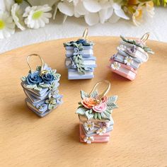 four small flower pots sitting on top of a wooden table