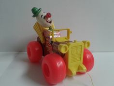 a toy tractor with a clown riding on it