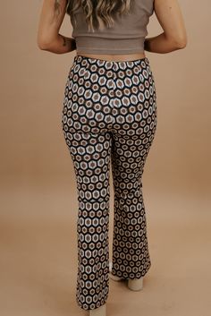 Take me back in time, this 70's inspired pant is featured in a true-to-size fit with a wide-leg style bottom and slimming high-waisted design. Radiate pure retro energy! Waist: High-rise elasticized Fabric: 100% Polyester Wide leg style botto Abstract design throughout Imported Fit: True to size!- Waist: High rise- Leg: Wide - Has some stretchModel Specs: Emily is wearing a size small in the photo.How will this item fit you? Check out our MODEL SPECS(Typical Sizing - Karli: S-Size 5/26 - 5ft 2in, Emily: S-Size 3/25 - 5ft 5in, Syd: L/XL- Size 15/ - 5ft 8in)﻿Need help with sizing? No problem! Join our VIP group on Facebook, Everyday Chic Boutique VIP Insiders to chat directly with our team and other customers just like you.Packaged with love and shipped from our warehouse in Wilmington, Ohio Retro Stretch Printed Bottoms, Retro Fitted Printed Pants, Checkered Bell Bottom Pants, 70’s Floral Pants, 1970s Fitted Full-length Pants, Retro Pants, Take Me Back, Everyday Chic, Vip Group